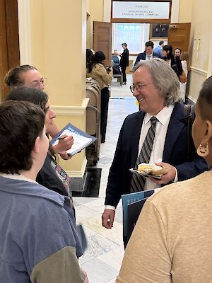 Housing leadership team members and MEJ staff speak with Rep. Drew Gattine of the Appropriations Committee.